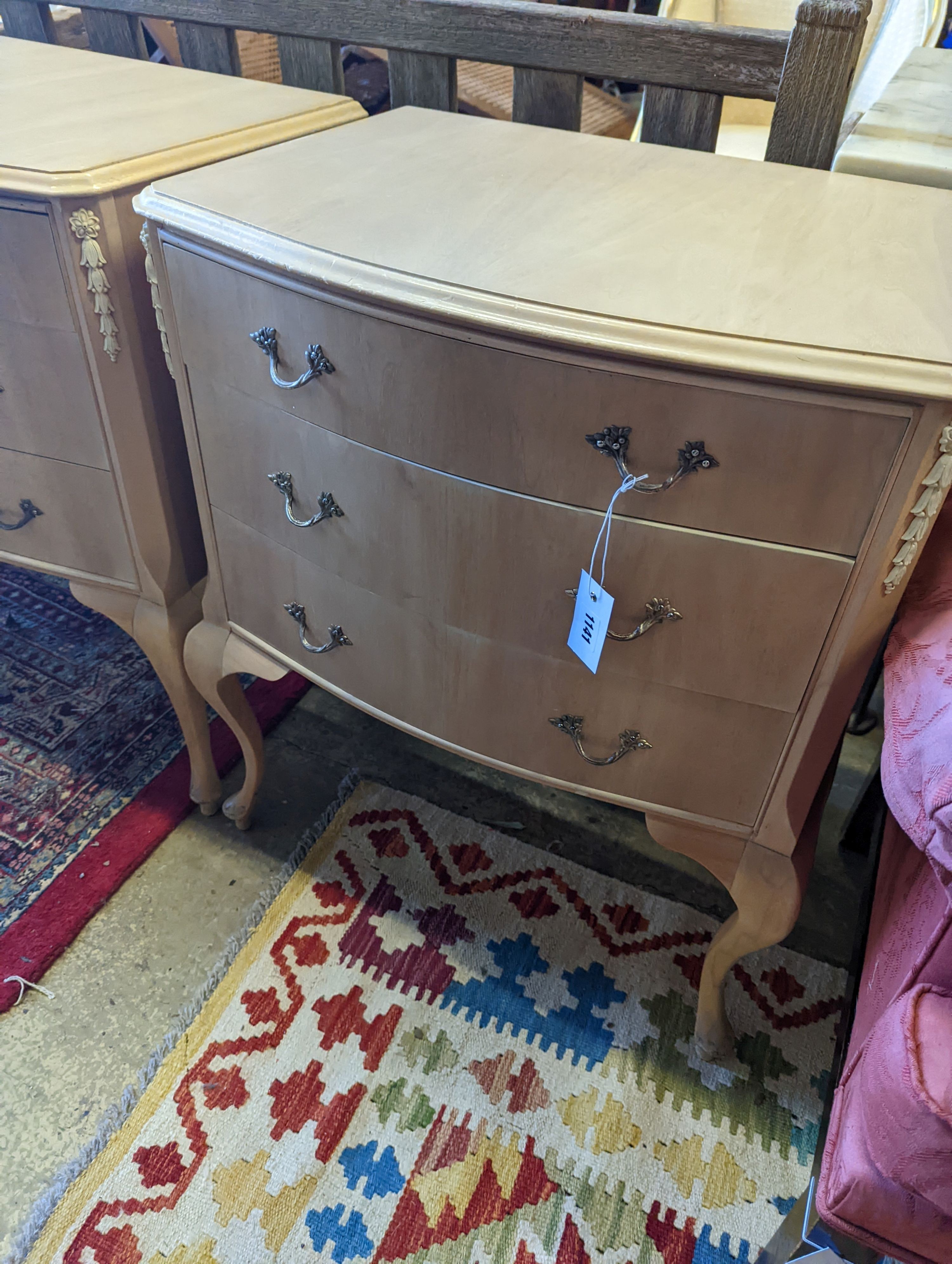 A pair of pale walnut three drawer bedside chests, width 60cm, depth 45cm, height 74cm